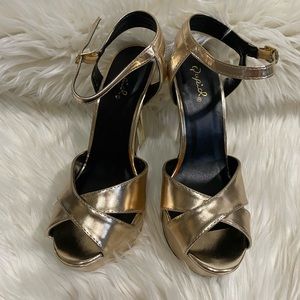 Gold platform stiletto heels by Qupid